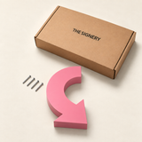 Pink curved arrow sign with fixing screws and The Signery presentation box